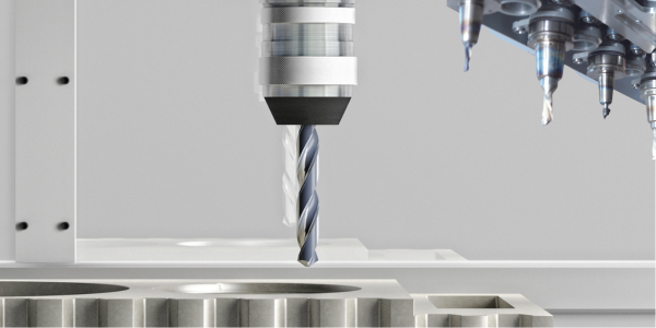 An image of a CNC drill in operation cutting through a metal workpiece