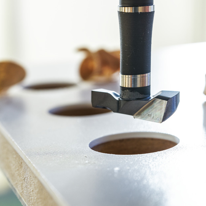 A cnc hinge drill bit machining holes into timber A cnc hinge drill bit machining holes into timber