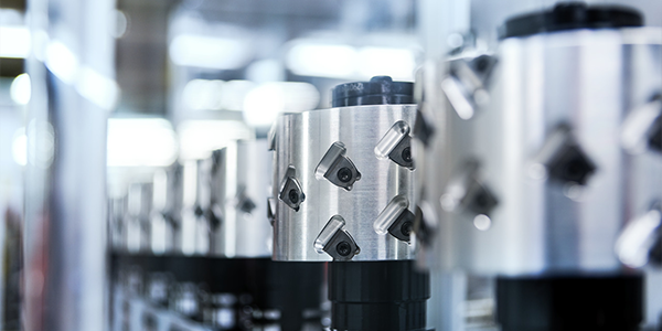 A picture of a row of Leitz WhisperCut cutter heads preparing to have their blades sharpened on a grinding machine