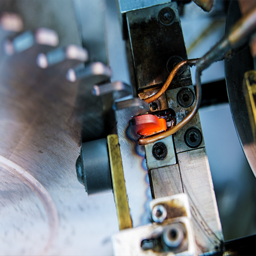 Re-tipping of a tooth on a carbide circular saw blade after sharpening